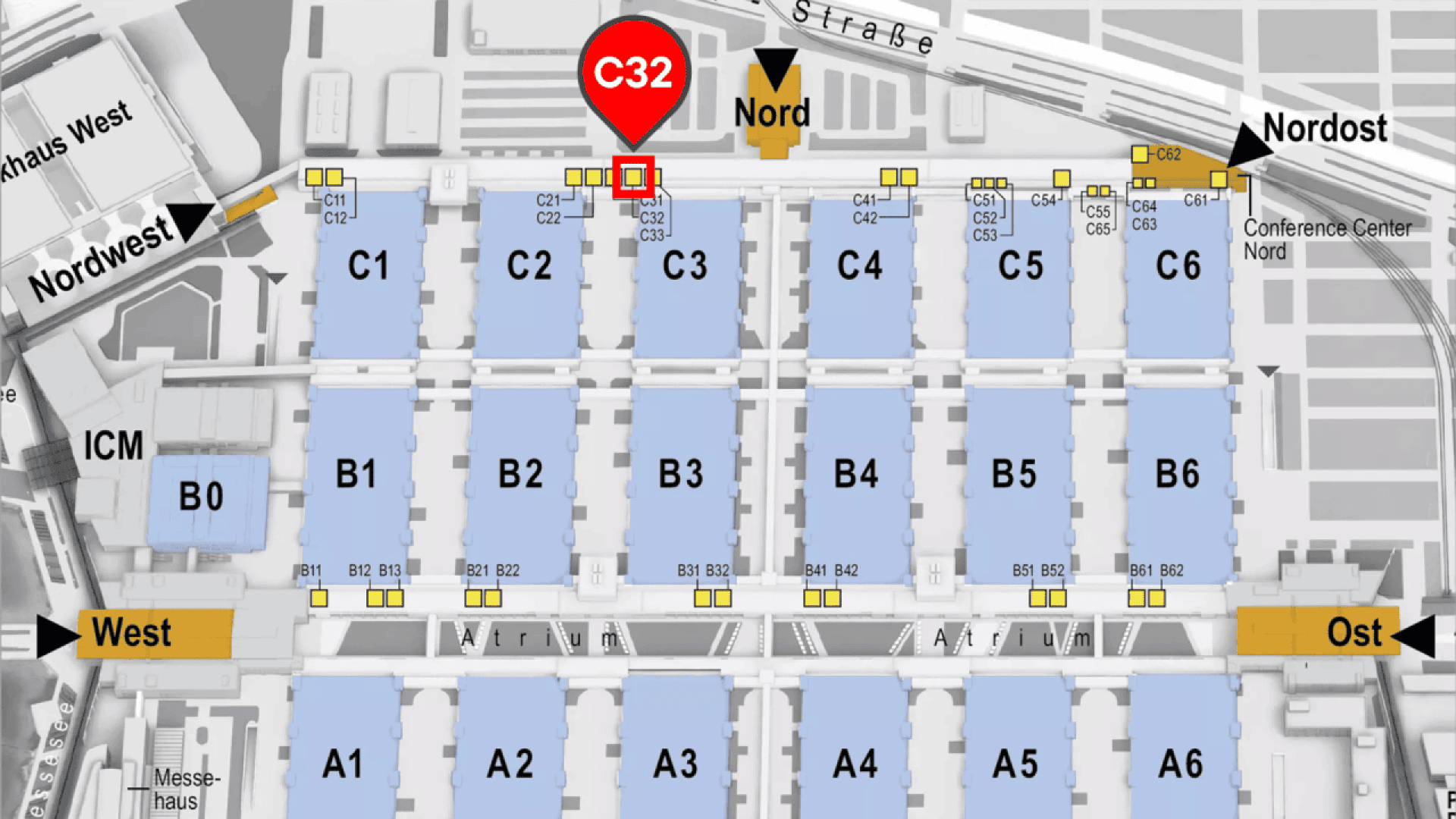 Map of a convention center with labeled halls A1–B6 and C1–C6. A red marker highlights booth C32 near the Nord entrance at the top. Directional arrows indicate West, Ost (East), Nordwest, and Nordost.