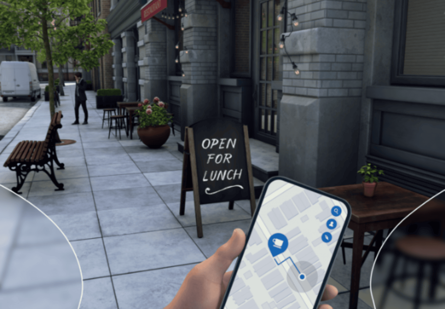 A person holding a smartphone displaying a map with a café icon stands on a sidewalk near a restaurant sign that reads "Open for Lunch". Tables, benches and fairy lights line the street.