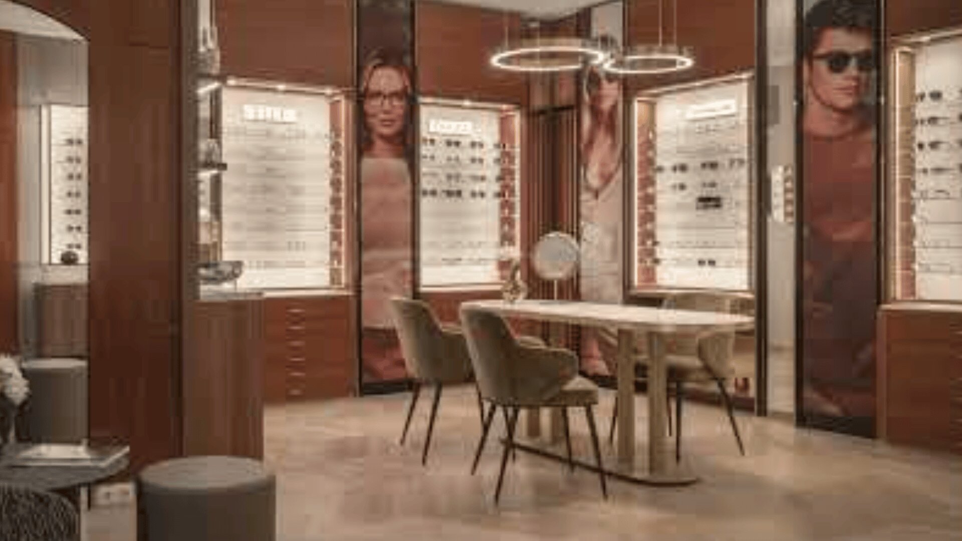 A modern eyewear store with wooden décor, showcases with glasses and sunglasses, a central table with velvet chairs and large portraits of spectacle wearers on the walls.