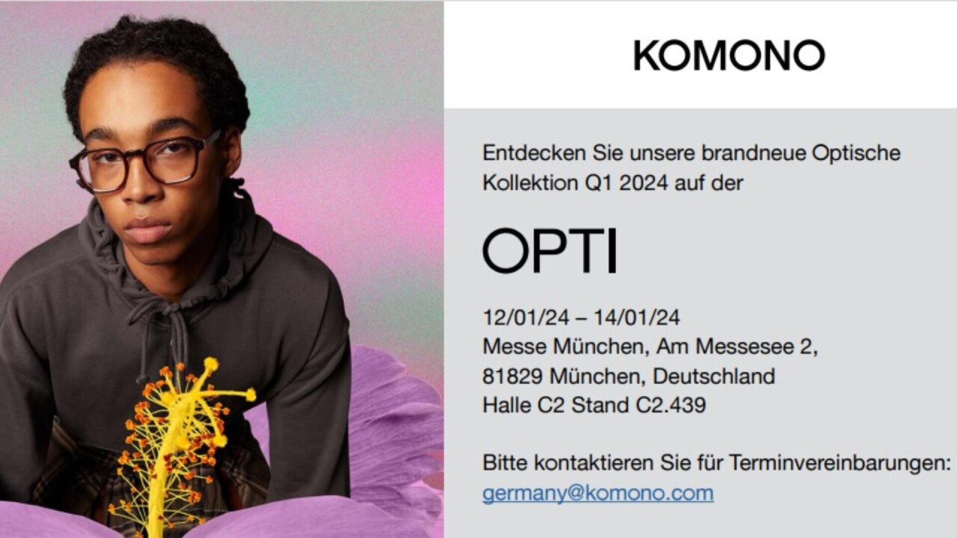 A person with short dark hair and glasses looks at the camera, sitting by a bright yellow and purple flower. The text announces KOMONOs new optical collection at OPTI 2024 in Munich, with contact info provided.