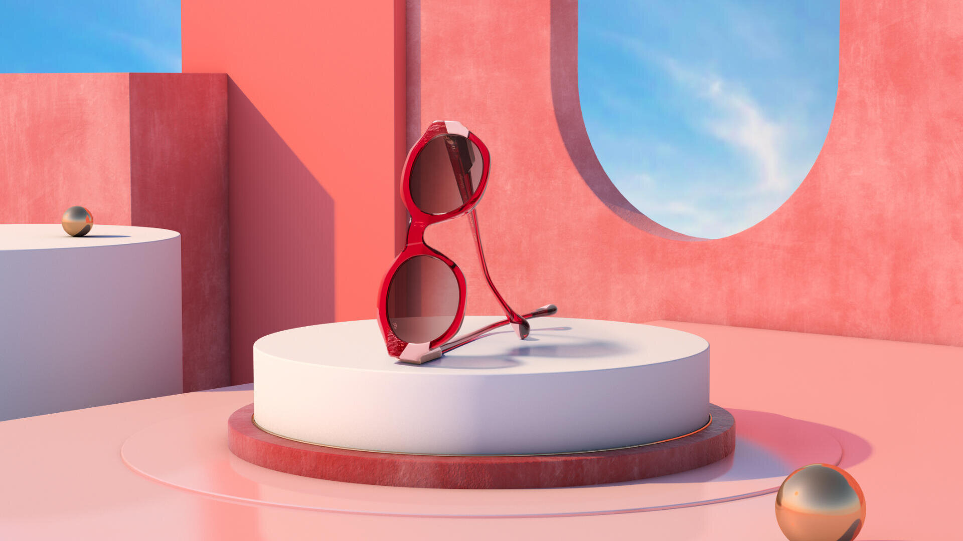 Eine rote Sonnenbrille wird auf einer runden weißen Plattform in einem modernen, minimalistischen rosafarbenen Ambiente mit geometrischen Formen, goldenen Kugeln und einem blauen Himmel präsentiert, der durch ein großes rundes Fenster sichtbar ist.