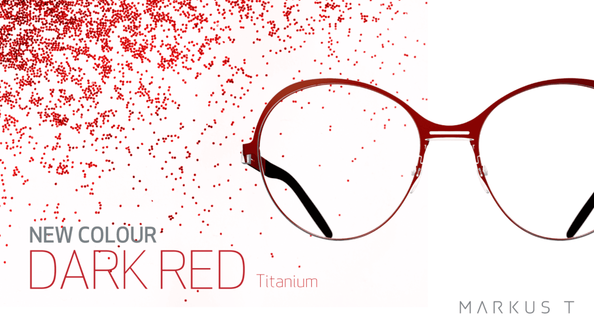 A pair of round, dark red eyeglasses is shown on a white background with scattered red dots. Text reads NEW COLOUR DARK RED Titanium and MARKUS T in the lower right corner.