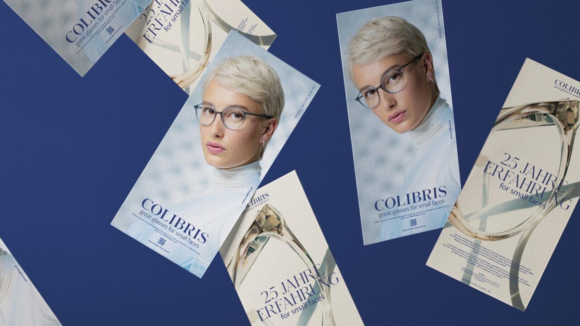 Several brochures featuring a woman with short blonde hair and glasses are scattered on a blue surface. The brochures read COLIBRIS and 25 Jahre Erfahrung for small faces.