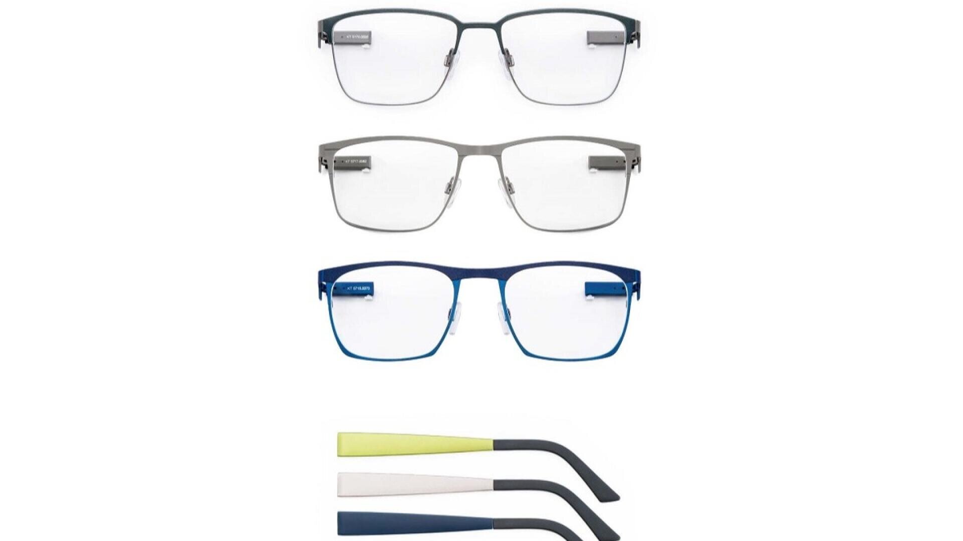 Three pairs of rectangular eyeglasses in black, silver, and blue are shown stacked vertically, with two sets of interchangeable temple arms in yellow and navy below them.