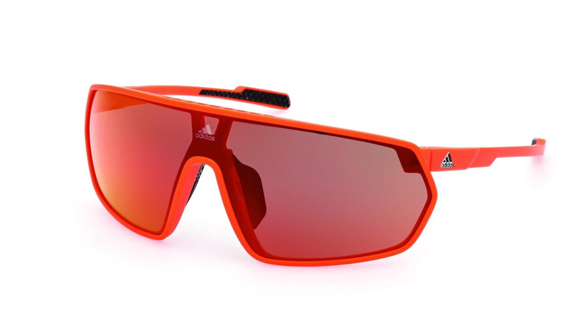 Red Adidas sports sunglasses with a bold, wraparound frame and red-tinted lenses. The Adidas logo is visible on the bridge and left temple. The glasses have a modern and sporty design.